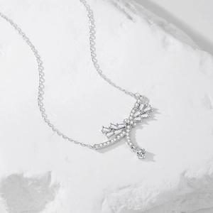 Elegant S925 sterling silver bow tassel necklace with sparkling crystals on white stone