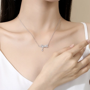 Elegant S925 silver bow tassel necklace with sparkling zircons worn by a female model