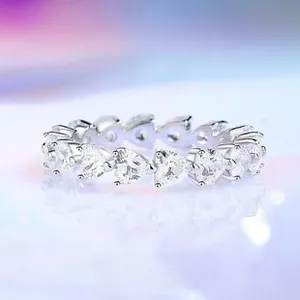 Macro shot of S925 sterling silver ring with a continuous row of heart-shaped zircons