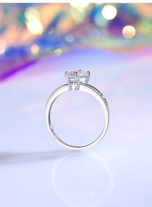 Macro detail of crown style silver engagement ring with 1ct round moissanite diamond