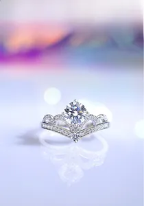 Macro detail of crown V-shaped ring with moissanite center stone and pavé diamonds