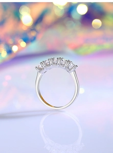 Macro side view of S925 silver ring with five round moissanite stones and bokeh background