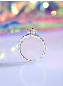 Macro side view of 1 carat moissanite ring with four-prong setting and crown detail
