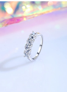 Macro shot of S925 sterling silver ring with five round moissanite stones and hallmark