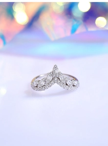 Macro shot of V-shaped S925 silver ring featuring round and baguette cut diamonds