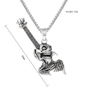 Detail showing vintage silver skull guitar pendant with 58mm height and 14g weight measurements
