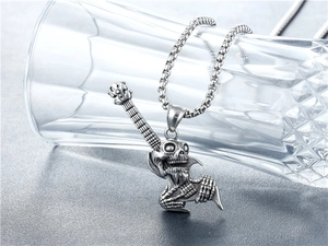 Detailed punk skull guitar pendant necklace in vintage silver steel on glass cup edge