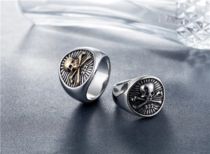 Macro shot of punk skull signet rings with vintage finish and engraved 322 symbol