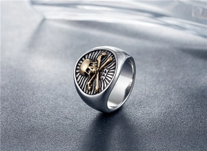Macro shot of silver signet ring with golden skull, crossbones and 322 engraving