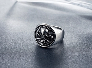 Macro view of punk skull crossbones and 322 engraving on a vintage steel ring