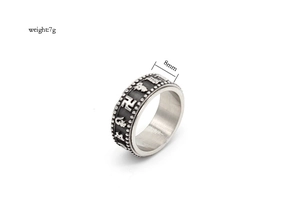 Detailed view of 8mm rotating titanium steel ring with embossed religious mantra patterns