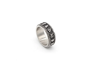 Macro view of vintage spinner ring featuring embossed letters and decorative beaded edges