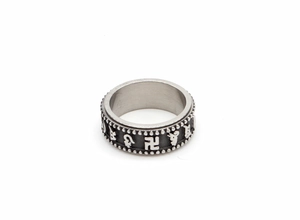 Detailed macro of rotating stainless steel ring with religious Sanskrit relief and textures