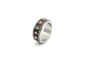 Detail of rotatable stainless steel ring with golden mantra symbols and silver beads