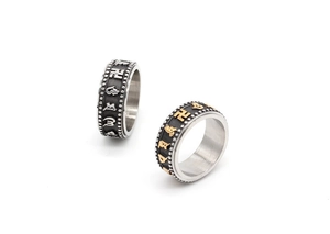 Detailed macro view of rotatable Tibetan Mantra rings with black and gold vintage finish
