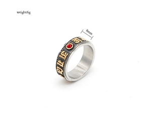 Detail view of 8mm rotating mantra ring with vintage finish and red zircon inlay