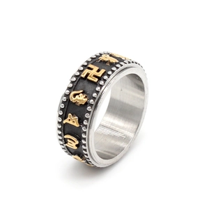 Buddhist spinner ring with golden mantra carvings on rotating black stainless steel band