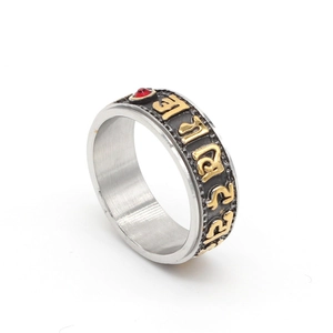 Rotating stainless steel mantra ring with golden relief and red rhinestone inlay
