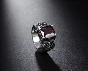 Macro shot of gothic viking ring featuring a square red ruby and cross engravings