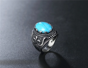 Detailed close-up of retro punk titanium steel ring with blue oval turquoise gemstone