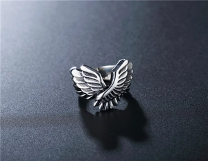 Macro detail of vintage silver angel wing ring showing oxidized feather textures