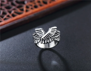 Macro shot of vintage titanium steel ring featuring detailed angel wing textures