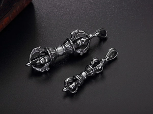Detailed close-up of retro stainless steel Vajra pendants in two different sizes