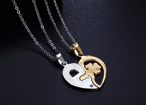 Detailed close-up of clover heart puzzle pendant necklaces with LOVE engraving for couples