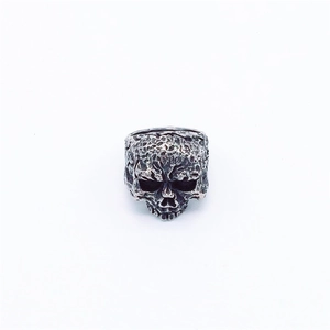 Macro shot of realistic skull ring with vintage silver oxidized texture and pitted details