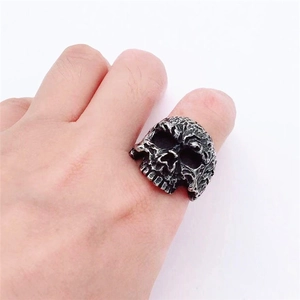 Close-up of vintage biochemical skull ring in blackened stainless steel on hand