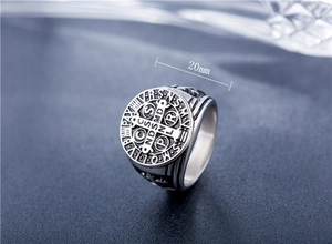 Detailed macro view of retro Saint Benedict Medal engraved on stainless steel cross ring