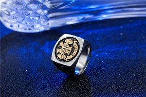 Macro shot of stainless steel Freemasonry ring with golden double-headed eagle and Latin motto