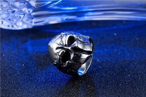 Detailed close-up of a vintage Spartan skull ring with a rugged punk metal texture