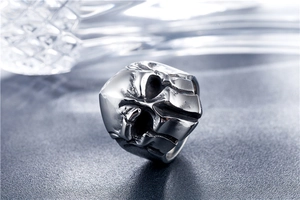 Macro shot of retro Spartan helmet skull ring with detailed dark oxidized steel texture