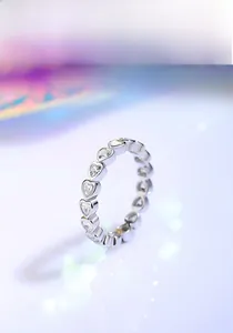 Macro shot of S925 sterling silver ring with heart-shaped cubic zirconia paving
