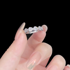 S925 sterling silver ring with five heart-shaped white zircons on a black background