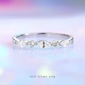 S925 sterling silver eternity ring with marquise and round cut stones on blue mirror