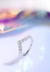 Macro detail of V-shaped sterling silver ring with delicate pave-set cubic zirconia