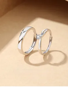 Macro shot of S925 sterling silver couple rings with adjustable open band and zircon stone