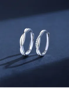 Detail of Mobius 925 silver couple rings with zirconia inlay and polished finish