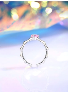 Macro view of adjustable S925 silver ring featuring pink round gemstone and wavy band