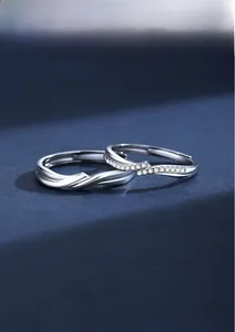 Macro shot of silver couple rings with polished finish and micro-set zircon accents