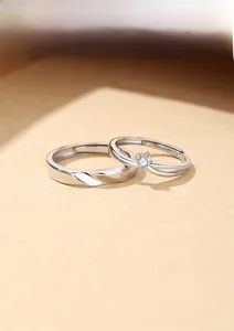 Detail of adjustable S925 sterling silver couple rings with twisted band and single stone