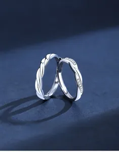 Detailed view of S925 sterling silver couple rings with twisted texture and zircon stones