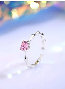 Macro detail of S925 silver ring featuring pink heart gem and bamboo texture band