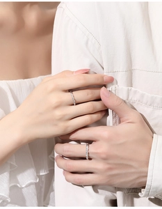 Close-up of S925 sterling silver couple rings with geometric textures on fingers