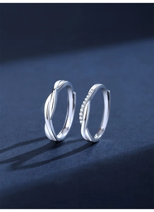 Detail of 925 silver couples rings with Mobius twist design and sparkling zircon insets