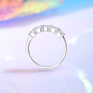 Elegant S925 sterling silver band ring with 5 sparkling zircon stones on a soft background