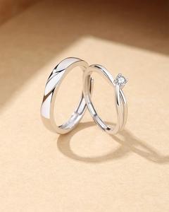 Detail of S925 silver couple rings featuring twisted band and four-prong solitaire setting