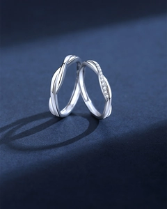 Close-up of S925 sterling silver Mobius couple rings with sparkling zircon inlay